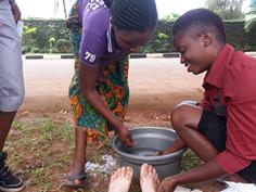 Natasha, Farai and Charity wash feet of Dr Susanna J Dodgson near UNZA