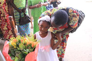 Rosalie, officer of GWRAZ, with granddaughter presenting Dr Susanna with roses on arrival in Zambia